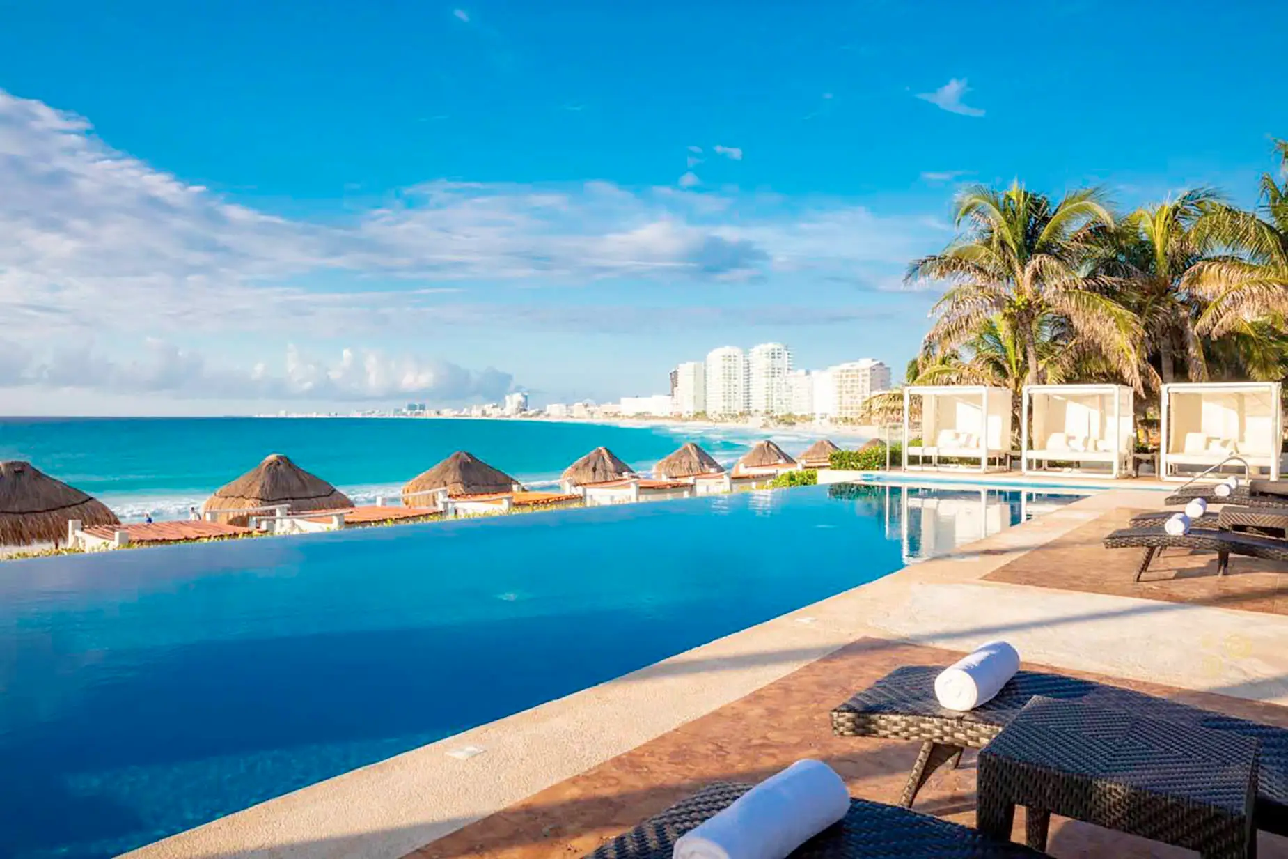 Luxury infinity pool with ocean views, cabanas, and loungers at our DEMO 3 resort.