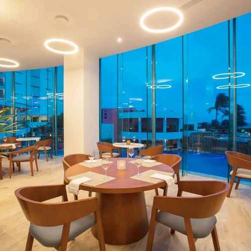 Elegant dining room with ocean view and DEMO 3 furniture.