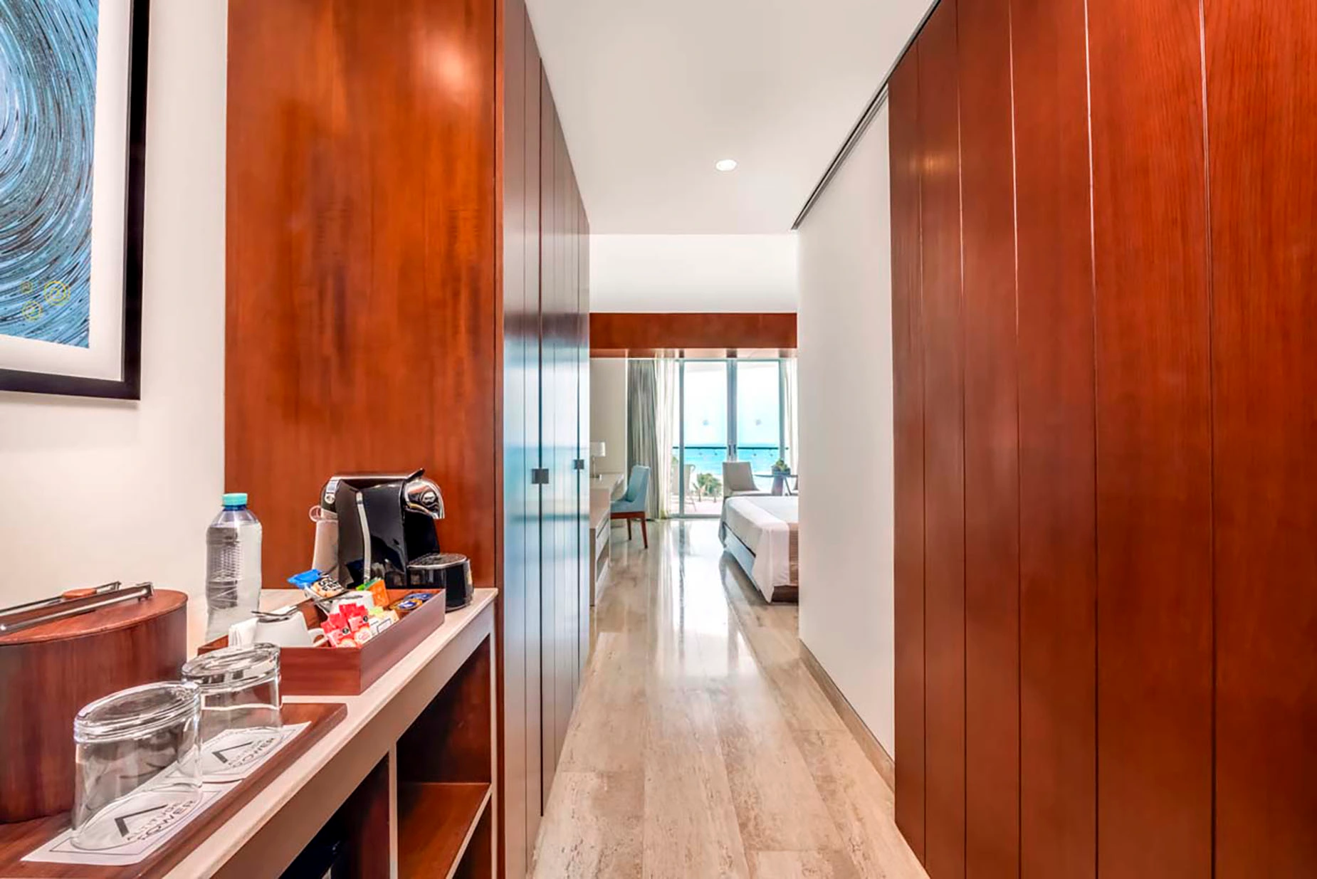 Hotel suite hallway with coffee maker, mini-bar, and ocean view DEMO 3.