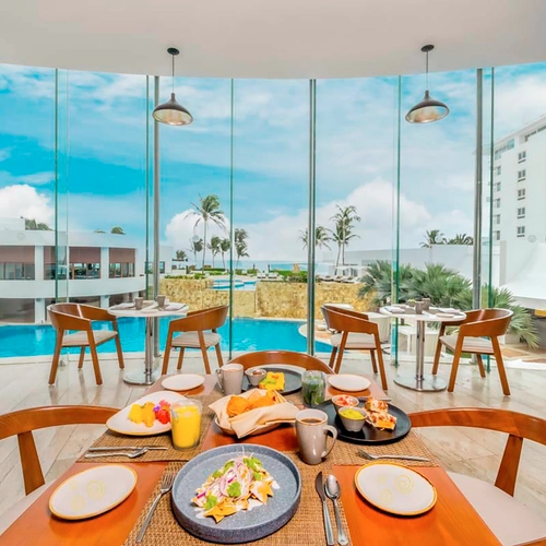 Hotel dining room with ocean view breakfast tables and pool. DEMO 3