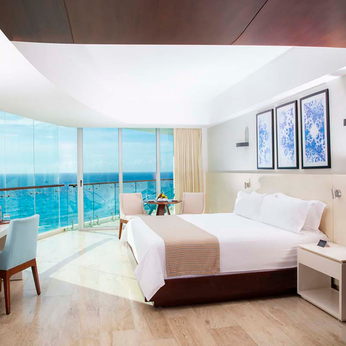 Luxury hotel room with ocean view DEMO 3, king bed, desk, and balcony.