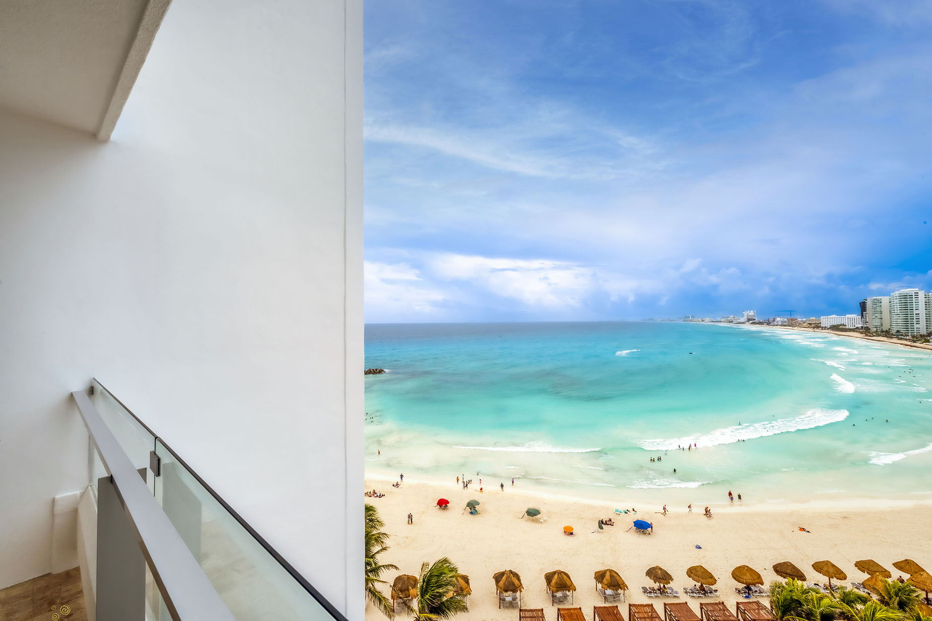 Balcony view of a tropical beach resort with turquoise waters and palm trees, a perfect DEMO 3 getaway.