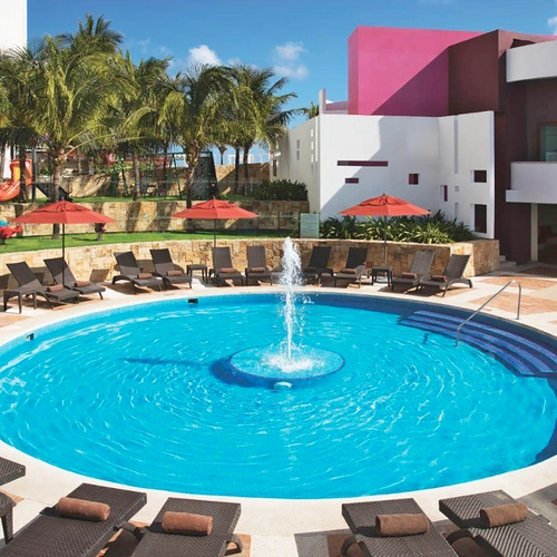 Resort swimming pool with fountain and lounge chairs, perfect for your DEMO 3 vacation.