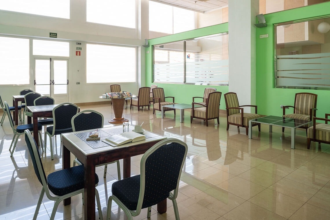 a room with tables and chairs and a sign that says exit