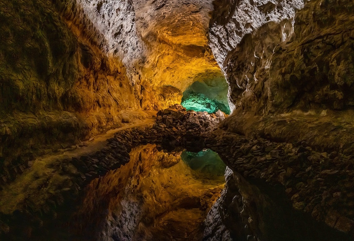 a cave with a green light in the middle of it