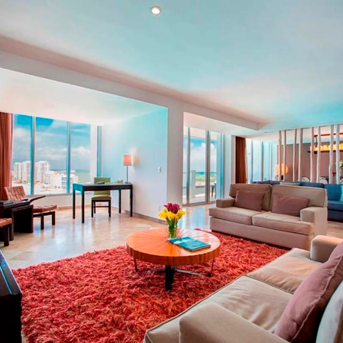 Spacious living room with ocean view, plush seating, and desk - perfect for DEMO 3.