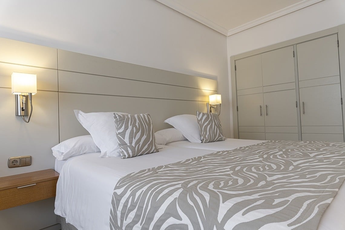 a bed with a zebra print blanket and pillows