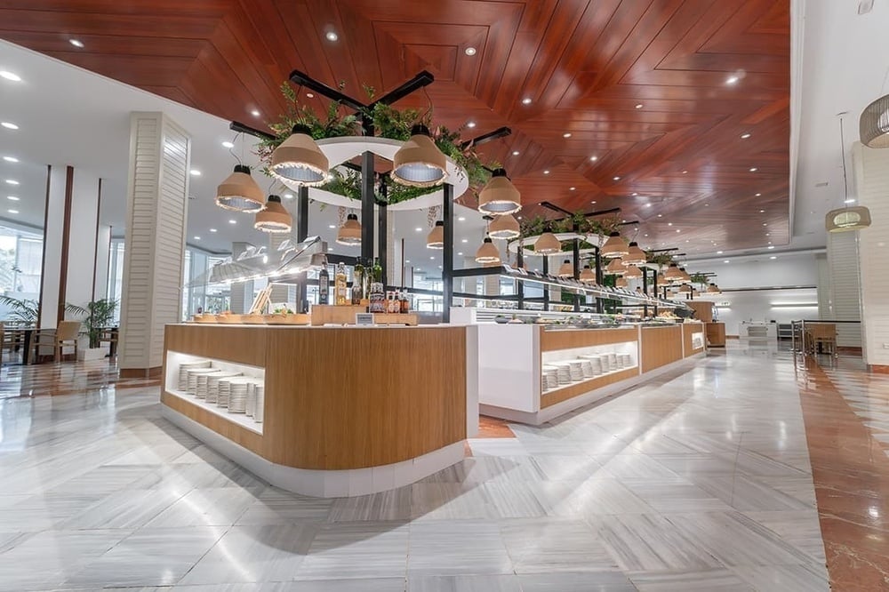 a buffet line in a restaurant with a wooden ceiling