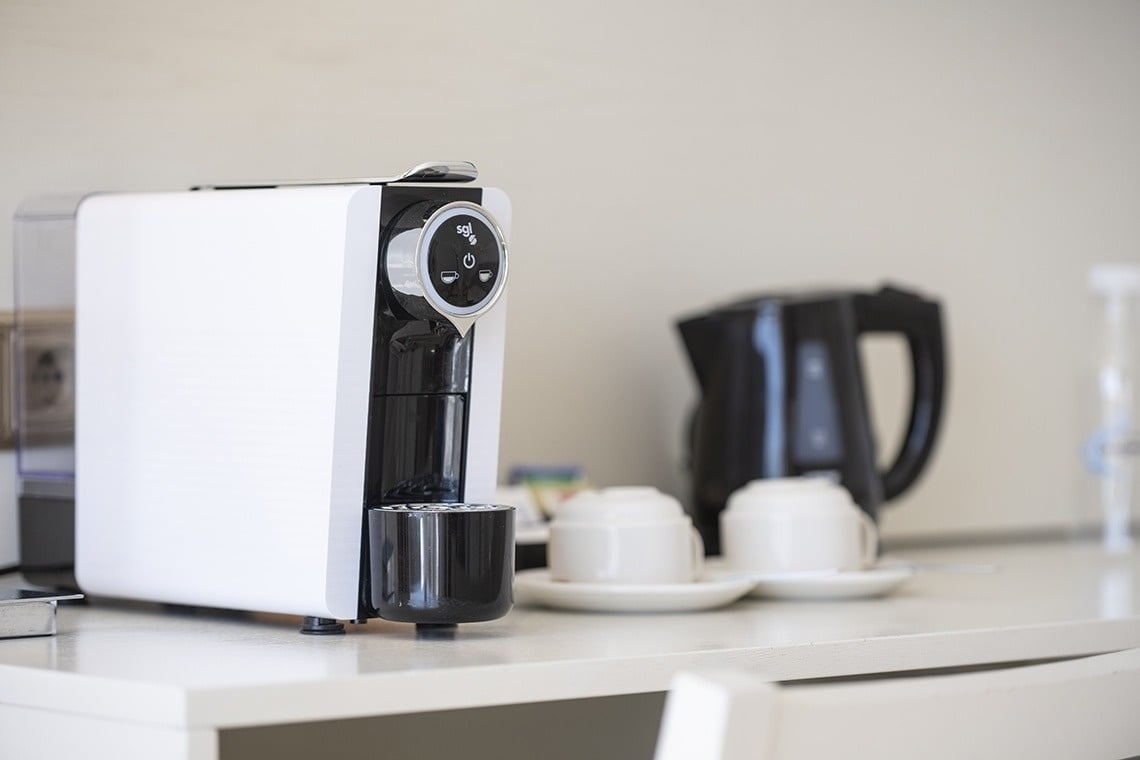 a white and black coffee maker with the word ' nespresso ' on it