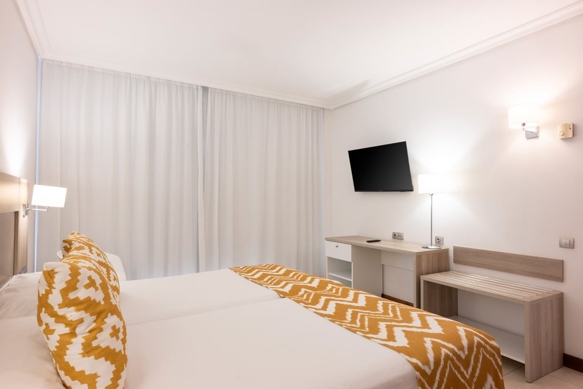 une chambre d' hôtel avec un lit et une télévision