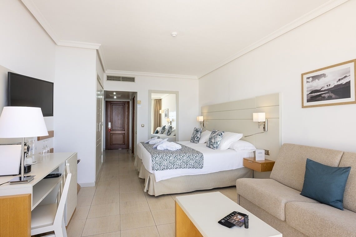 a hotel room with a large bed and a couch