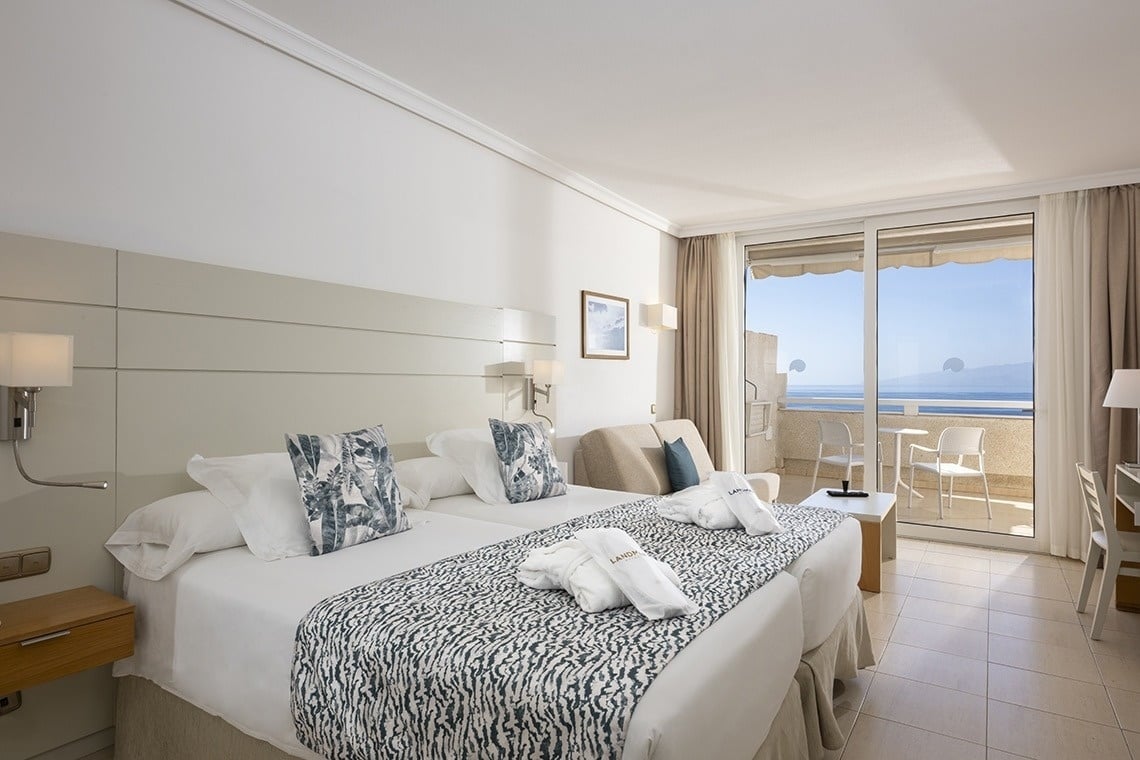 ein Hotelzimmer mit zwei Betten und einem Balkon