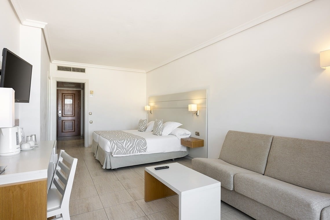 a hotel room with a bed and a couch