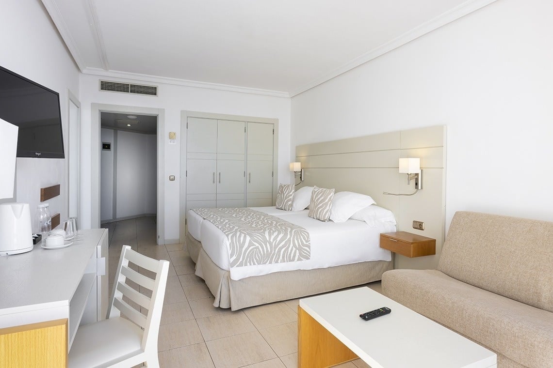 a hotel room with two beds and a couch