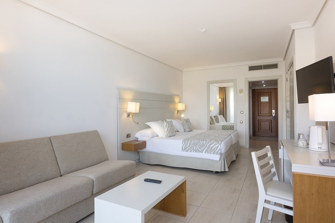 a hotel room with a bed and a couch