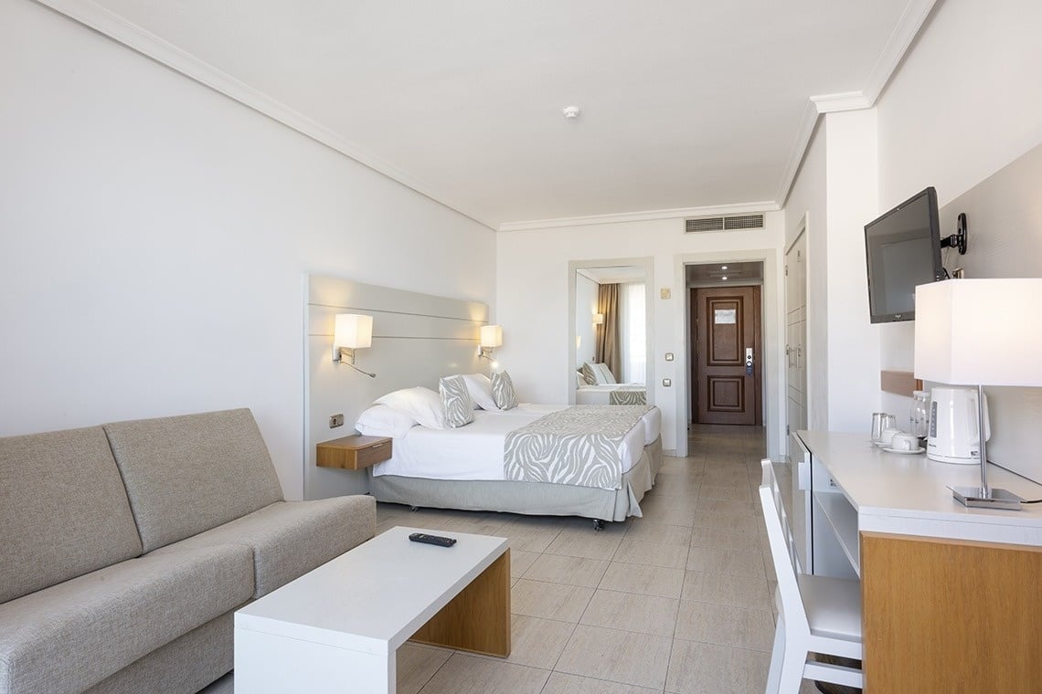 a hotel room with a bed and a couch