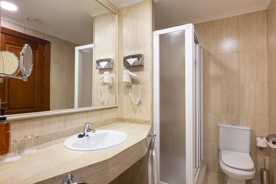 a bathroom with a toilet a sink and a mirror