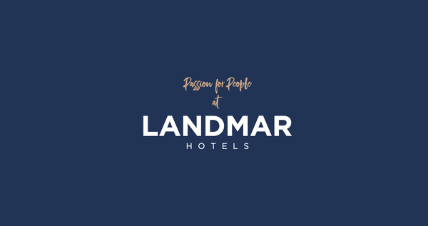 a logo for landmar hotels with a blue background