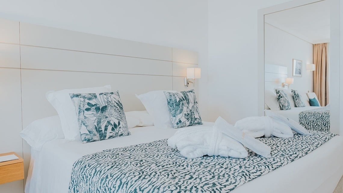 a hotel room with a bed and a mirror