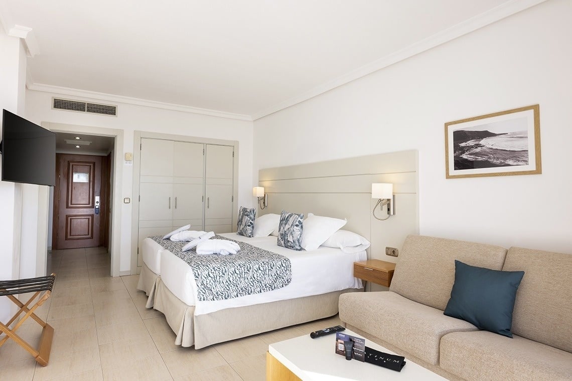 a hotel room with two beds and a couch