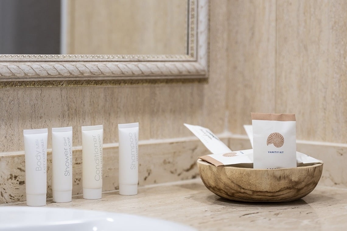 a bathroom counter with bottles of body wash conditioner shower gel and shampoo