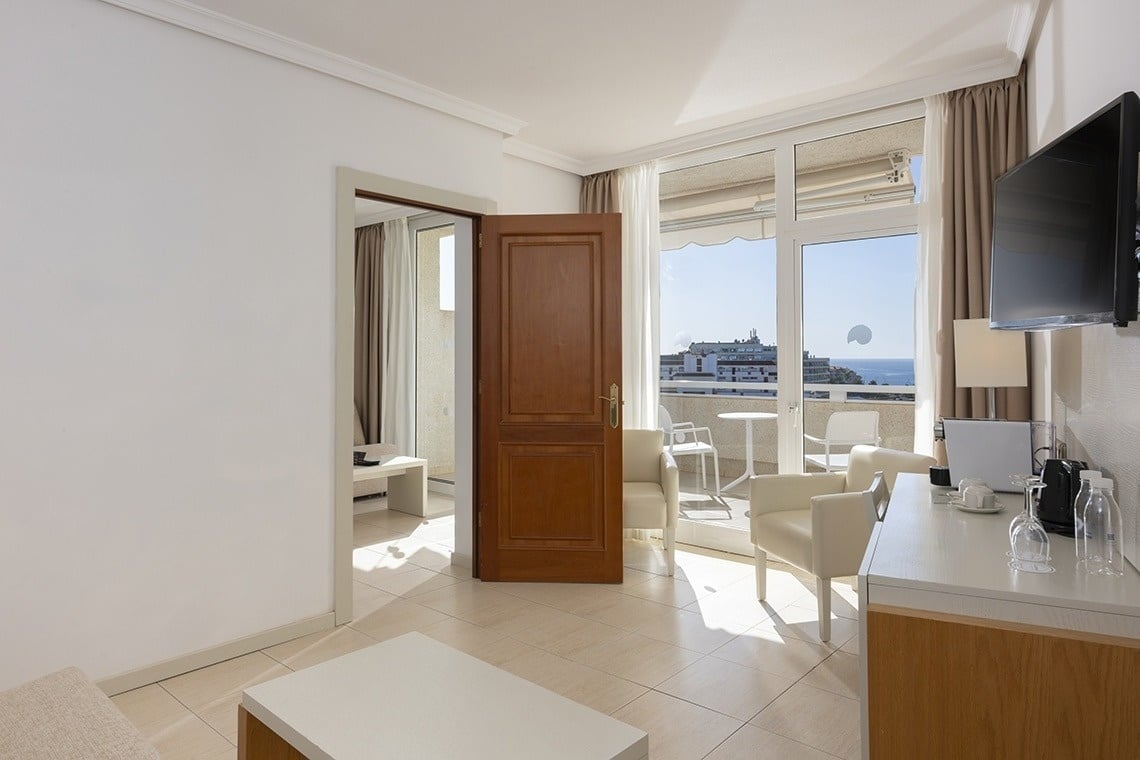 a hotel room with a view of the ocean