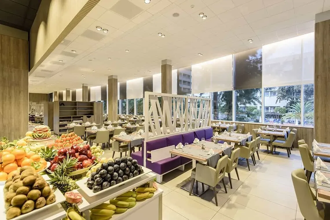 ESTIVAL: Fresh fruit buffet display and elegant dining tables.