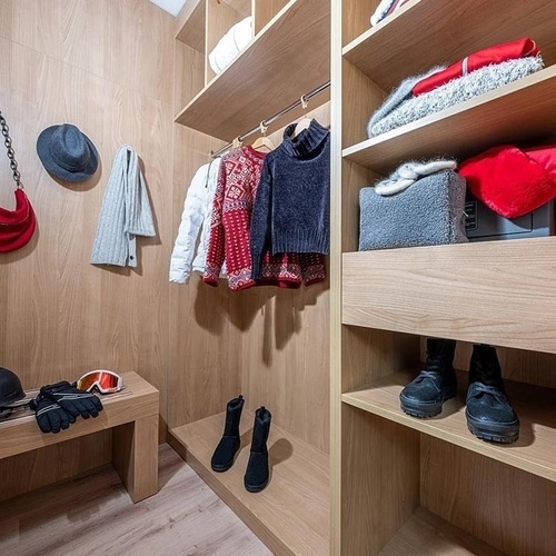 a walk in closet with clothes and a helmet that says ' salomon ' on it
