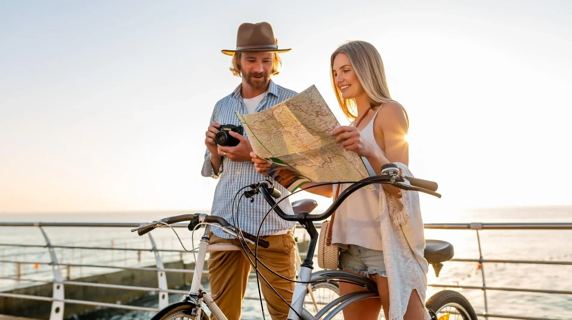 Couple with map & bike planning adventures - Experiences | Estival Group Hotels