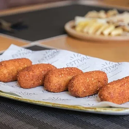 Homemade croquettes served on ESTIVAL: Corporate paper, a delicious appetizer.