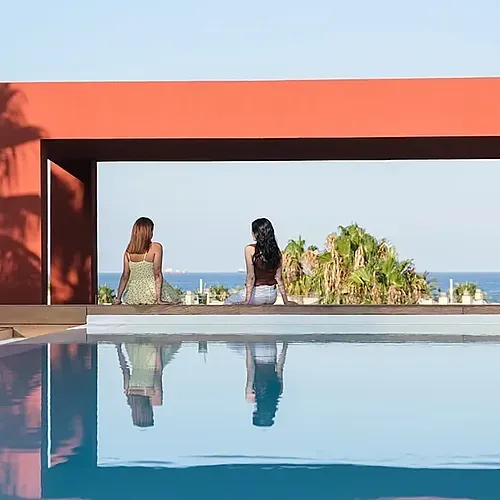 Two women relax by the pool at Estival Park Almaris | Estival Group | Tarragona.