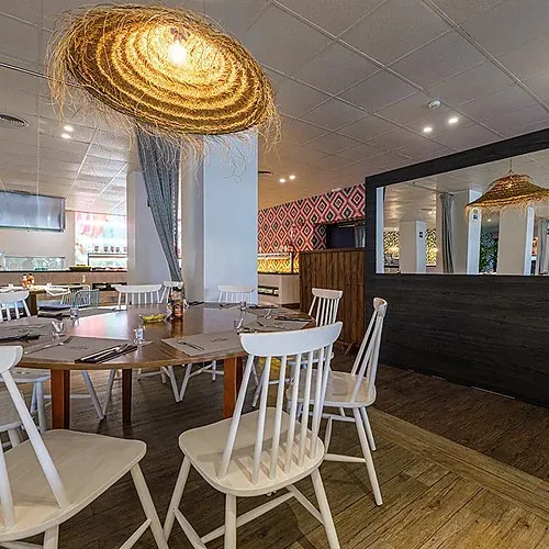 Dining room at Estival Islantilla 4* with rattan lamps and white chairs. | Huelva, Costa de la Luz.