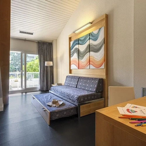 ESTIVAL: Corporate family room with trundle bed and abstract art.