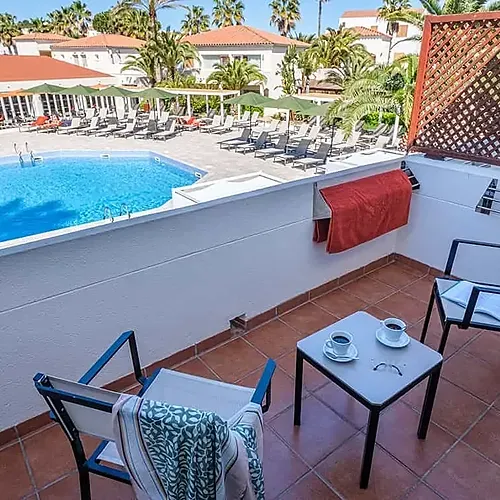 ESTIVAL: Corporativa balcony with pool view, perfect for relaxation.