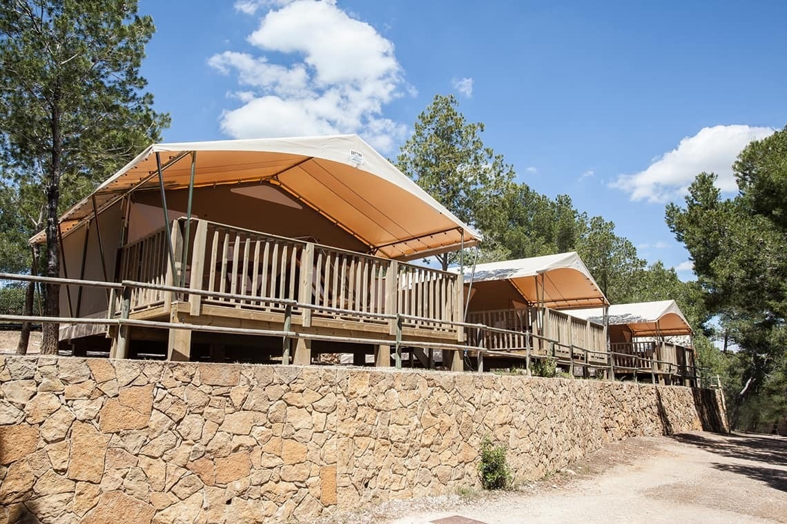 a row of tents are sitting on top of a stone wall
