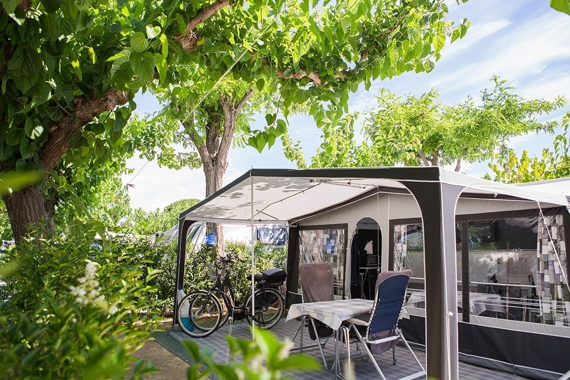 a tent with a table and chairs underneath it