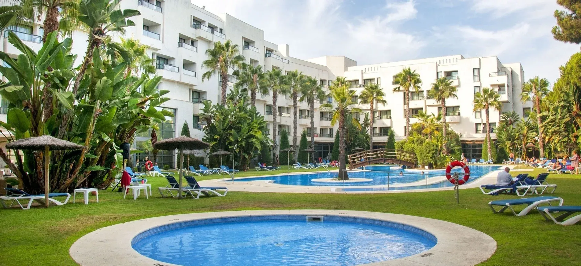 Hotel with pools, palm trees, and sun loungers. Destinations and Establishments | Estival Group | Official Web