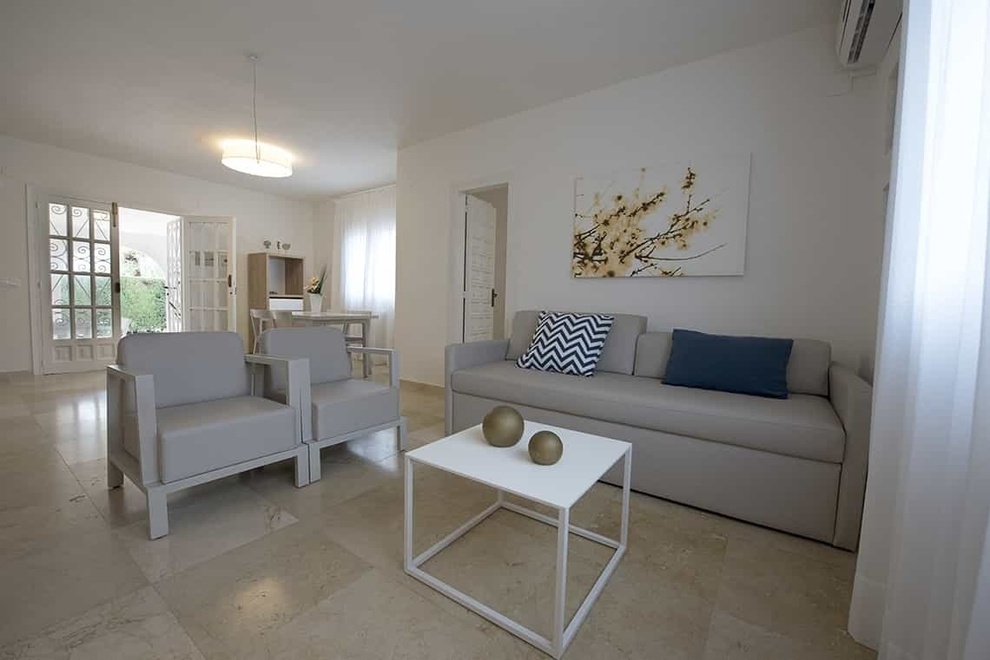 a living room with a couch and two chairs