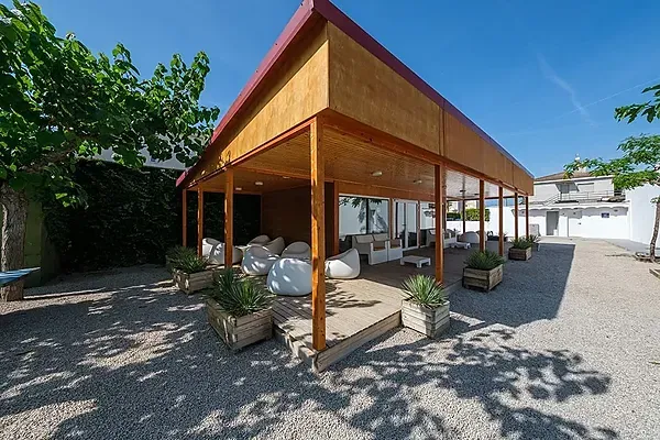 Relájate en el lounge exterior ESTIVAL: Corporativa, con asientos cómodos y plantas.