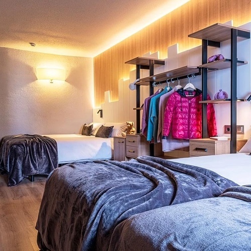 a hotel room with two beds and a tv