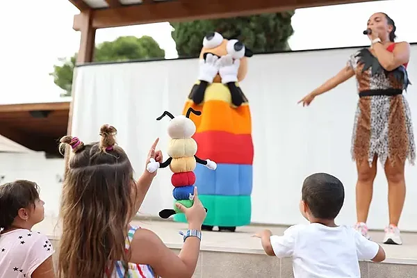 ESTIVAL: Enfants profitent d'un spectacle interactif avec mascotte et animatrice.