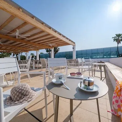 ESTIVAL Corporate terrace with tables and chairs, perfect for relaxing.