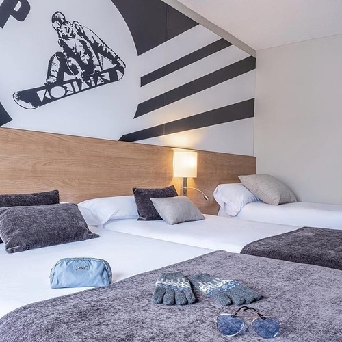 a hotel room with a snowboarder on the wall