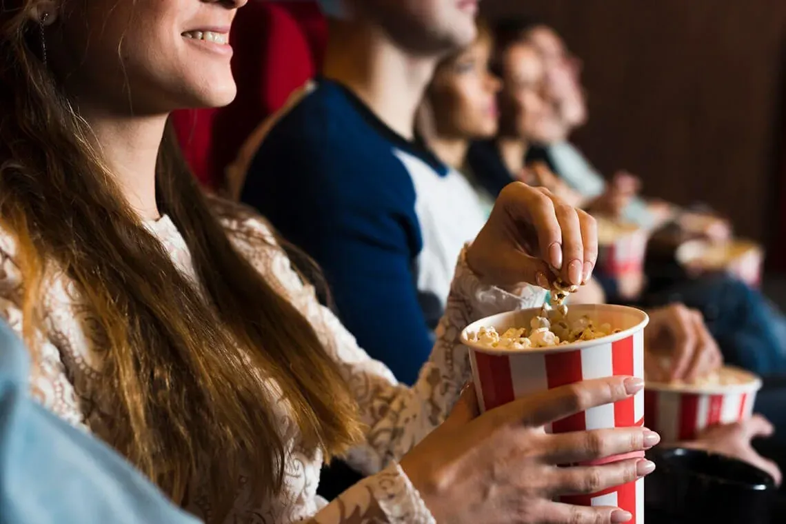 ESTIVAL: Corporate. People enjoying popcorn in a cinema.