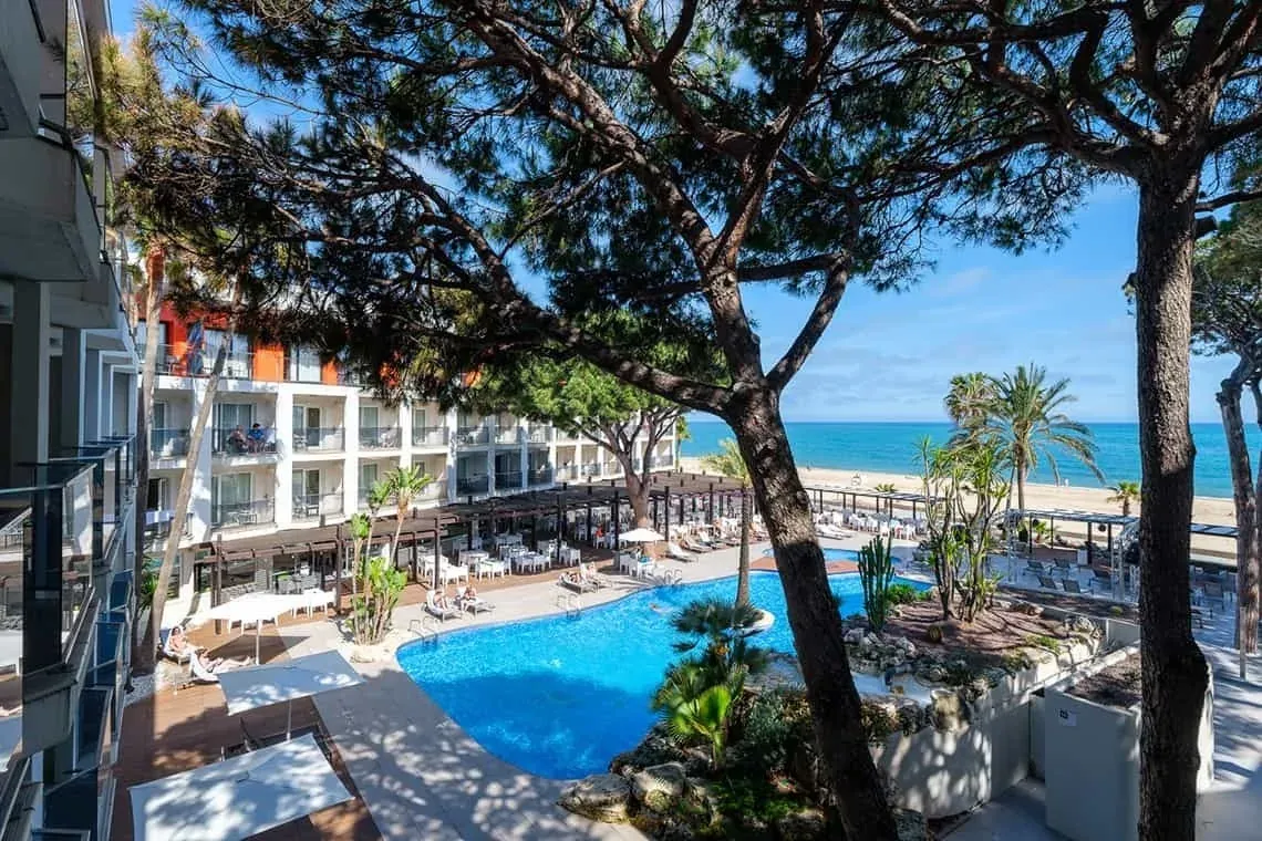 a large swimming pool in front of a hotel