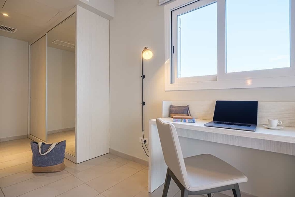 a desk with a laptop and a book on it