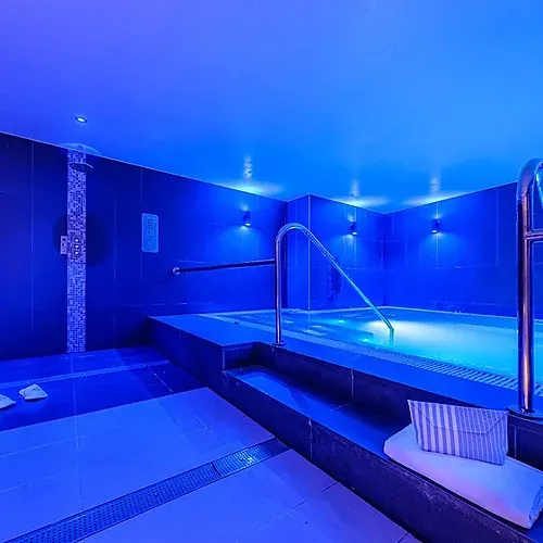 Hotel Sporting Andorra | Indoor pool & spa area with blue lighting.