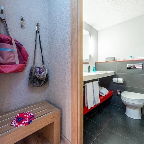 a bathroom with a toilet a sink and a phone