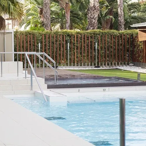 ESTIVAL: Corporate pool with palm trees and outdoor jacuzzi.