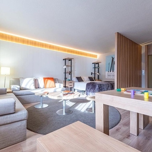 a living room with a couch and a table with a board game on it